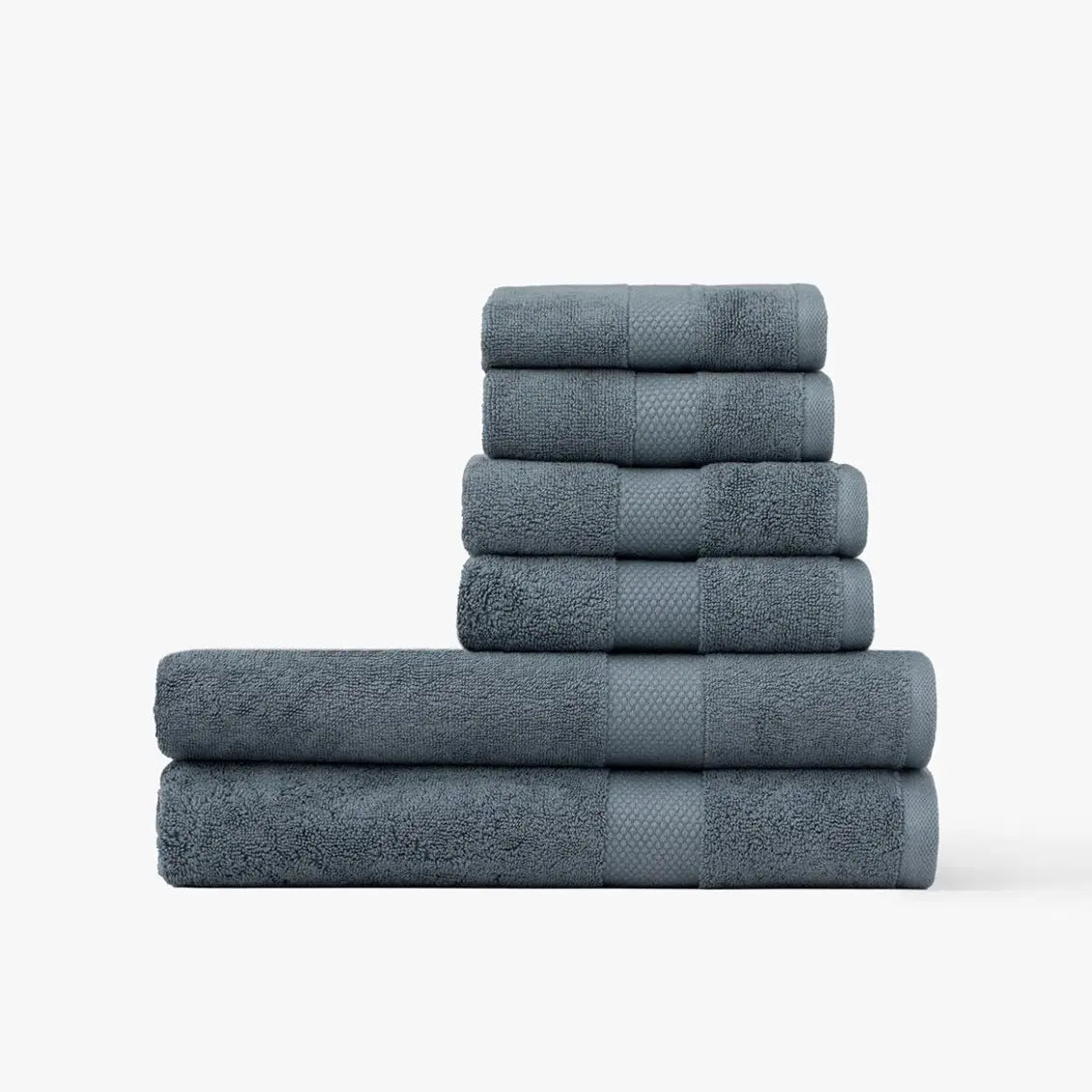 Stack of blue Premium Turkish Cotton towels on a white background