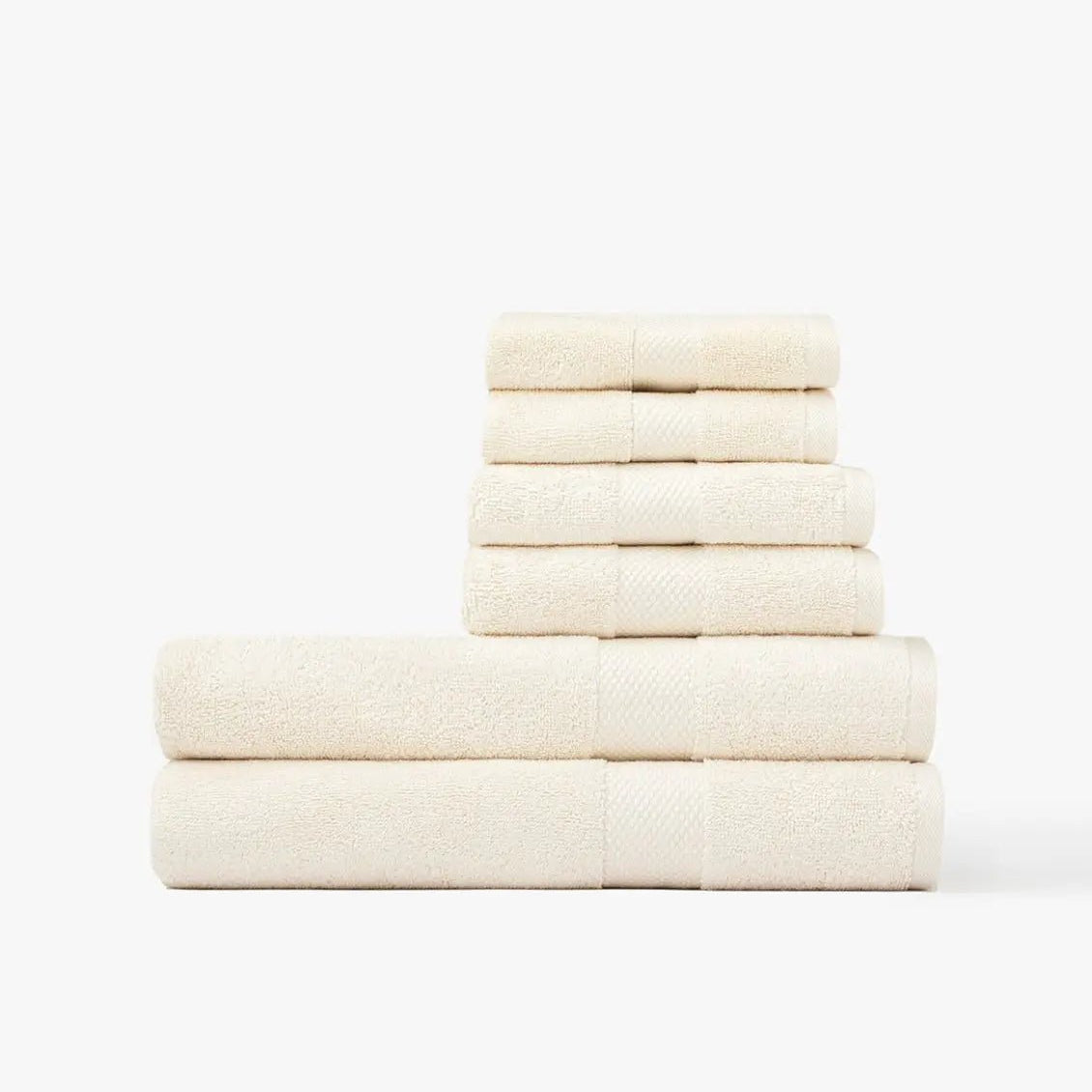 Stack of cream Premium Turkish Cotton towels on a white background