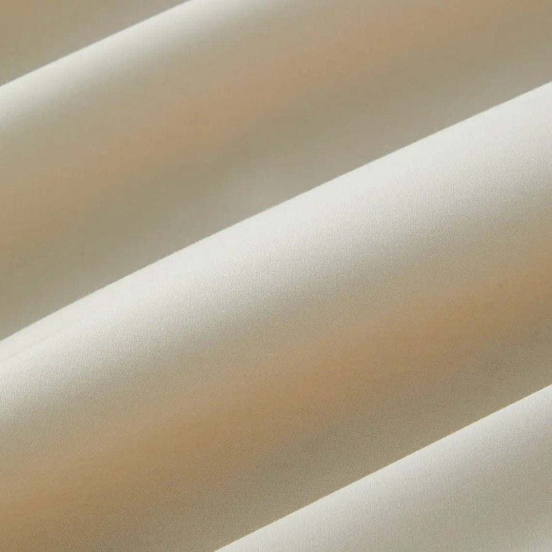 Close-up of beige sheet set fabric with a soft texture
