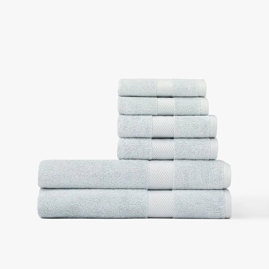 Stack of light blue Premium Turkish Cotton towels on a white background