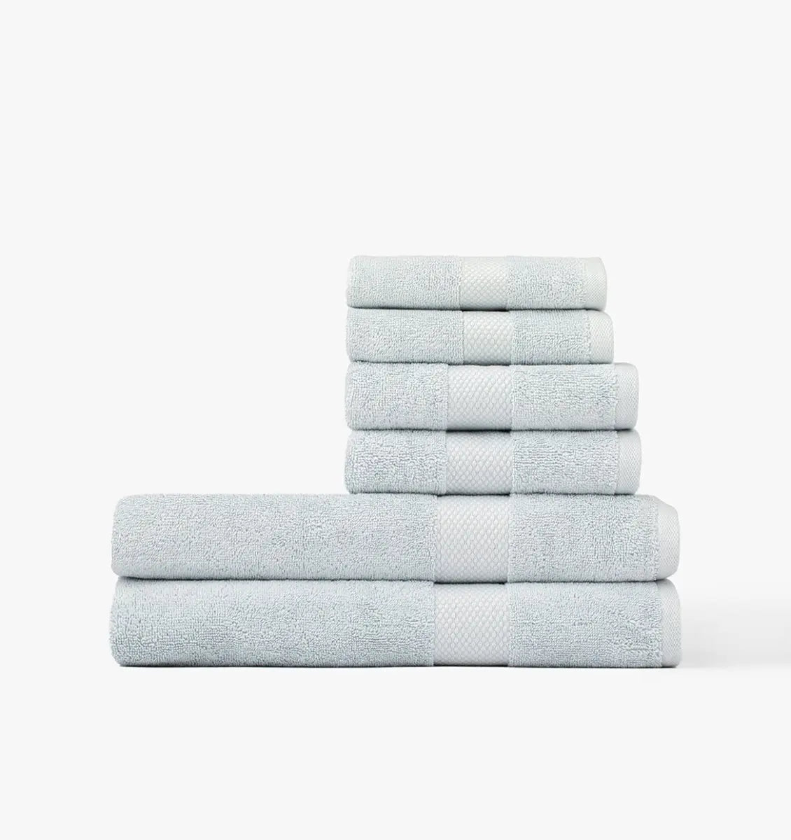 Stack of light blue Premium Turkish Cotton towels on a white background