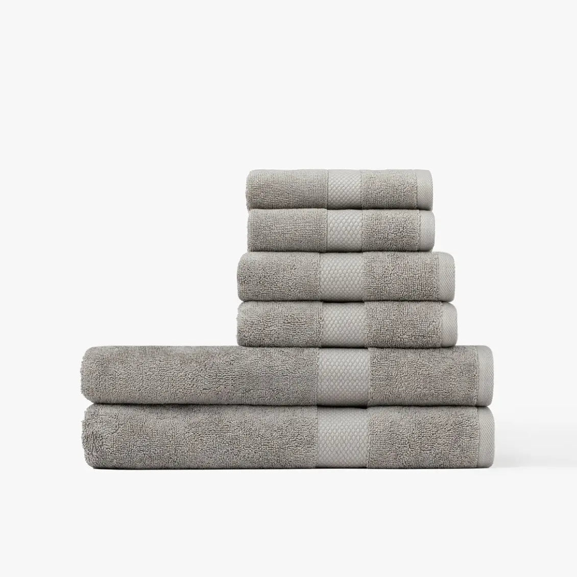Stack of gray Turkish Cotton towels on a white background