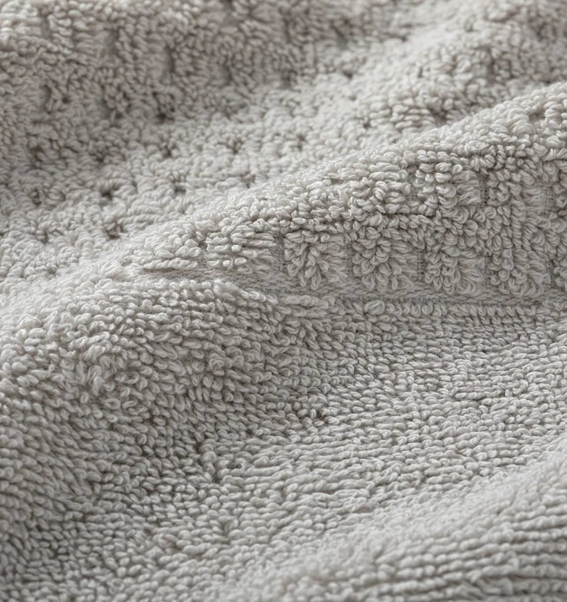 Close-up of light gray waffle towel fabric texture