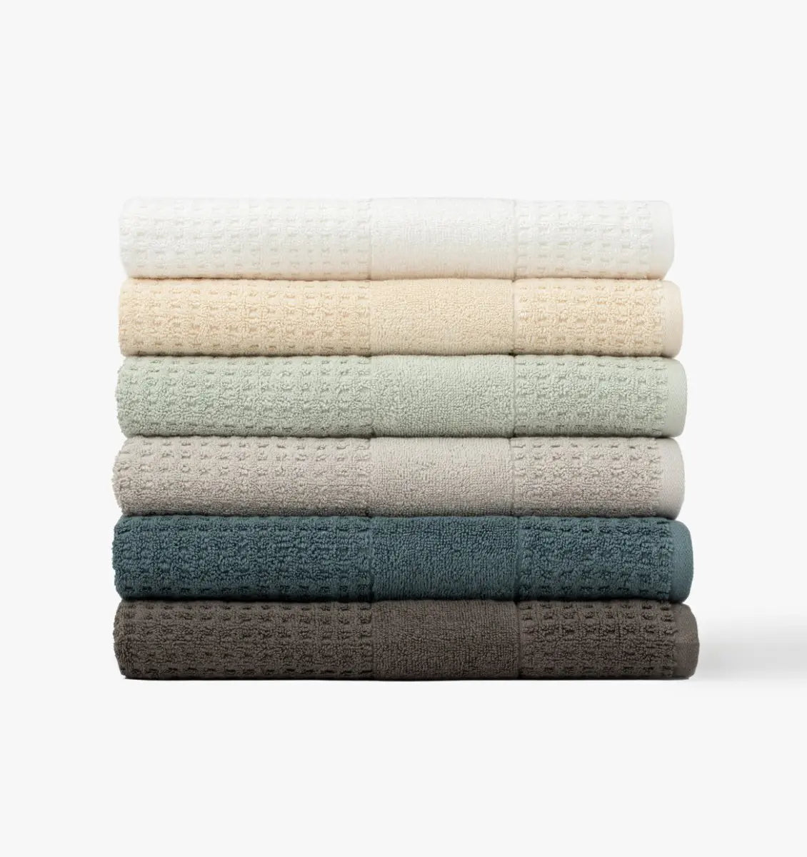Stack of lightweight waffle towels in various colors