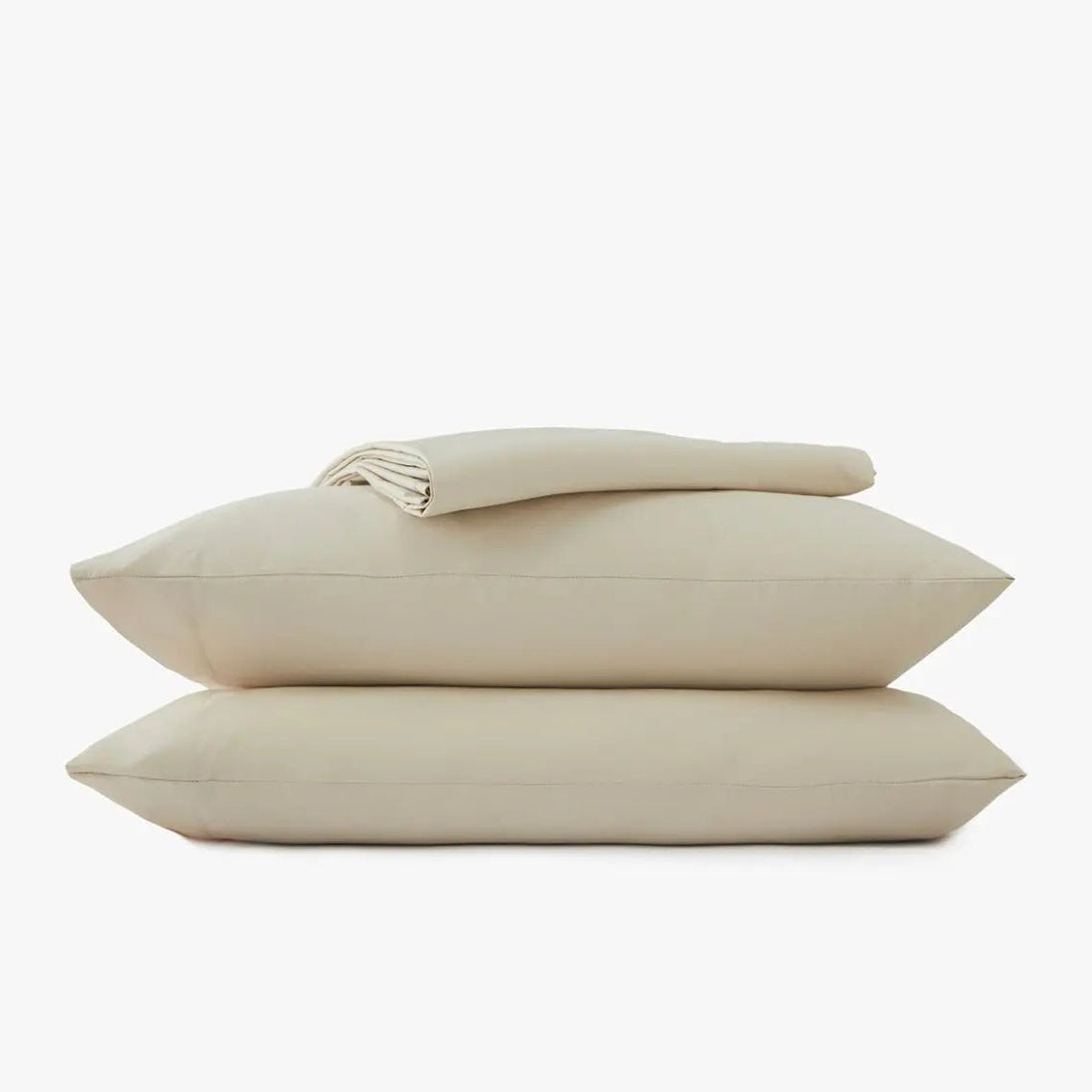 Beige bed sheets and pillowcases on a white background