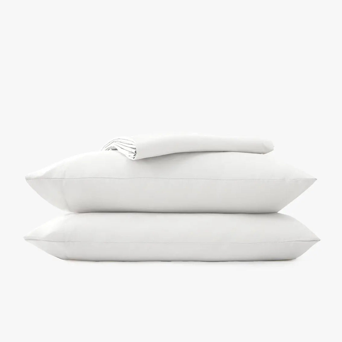 Stack of white pillow cases and sheets on a white background