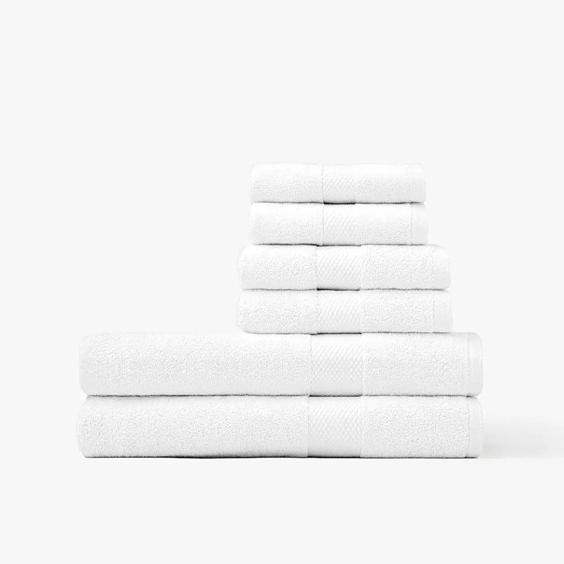 Stack of white Turkish cotton towels on a white background