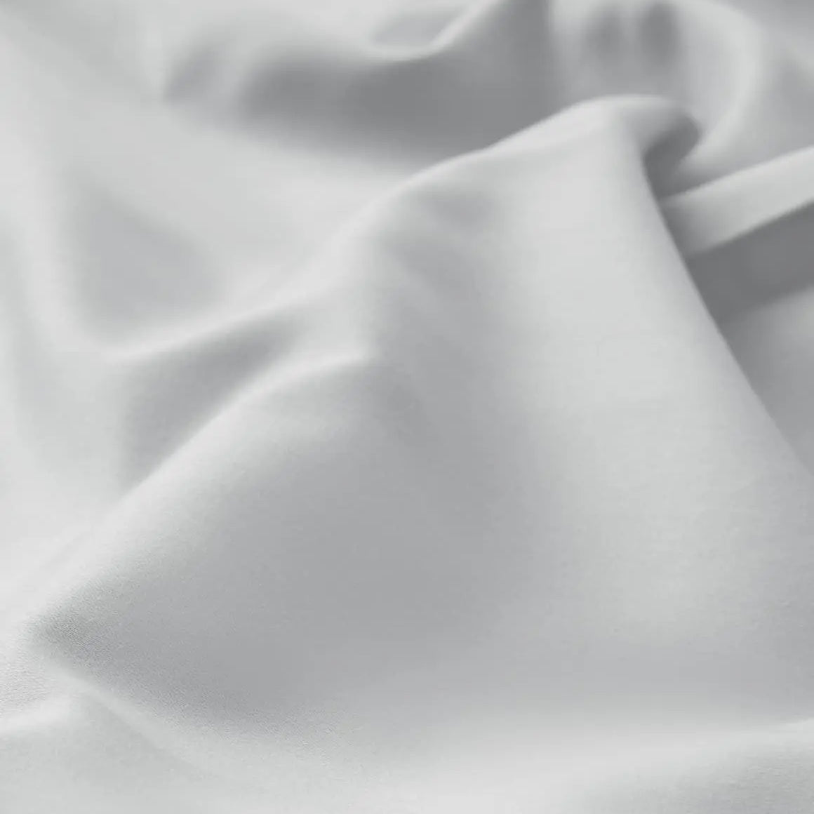 Close-up of gray bed sheet fabric with folds