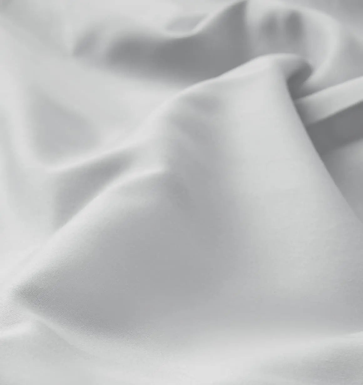 Close-up of gray bed sheet fabric with folds