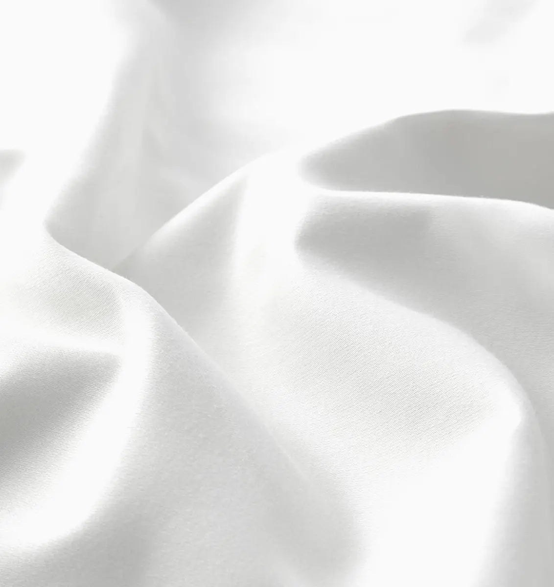 Close-up of white sheet set fabric with folds