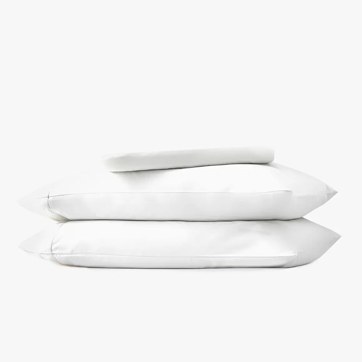 Stack of white pillows and bed sheets on a white background