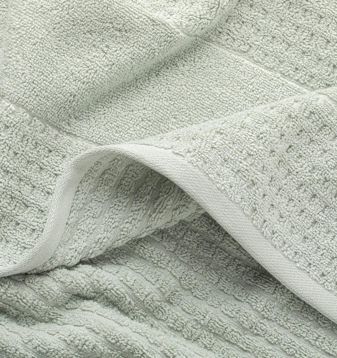 Close-up of a textured light green mist waffle towel