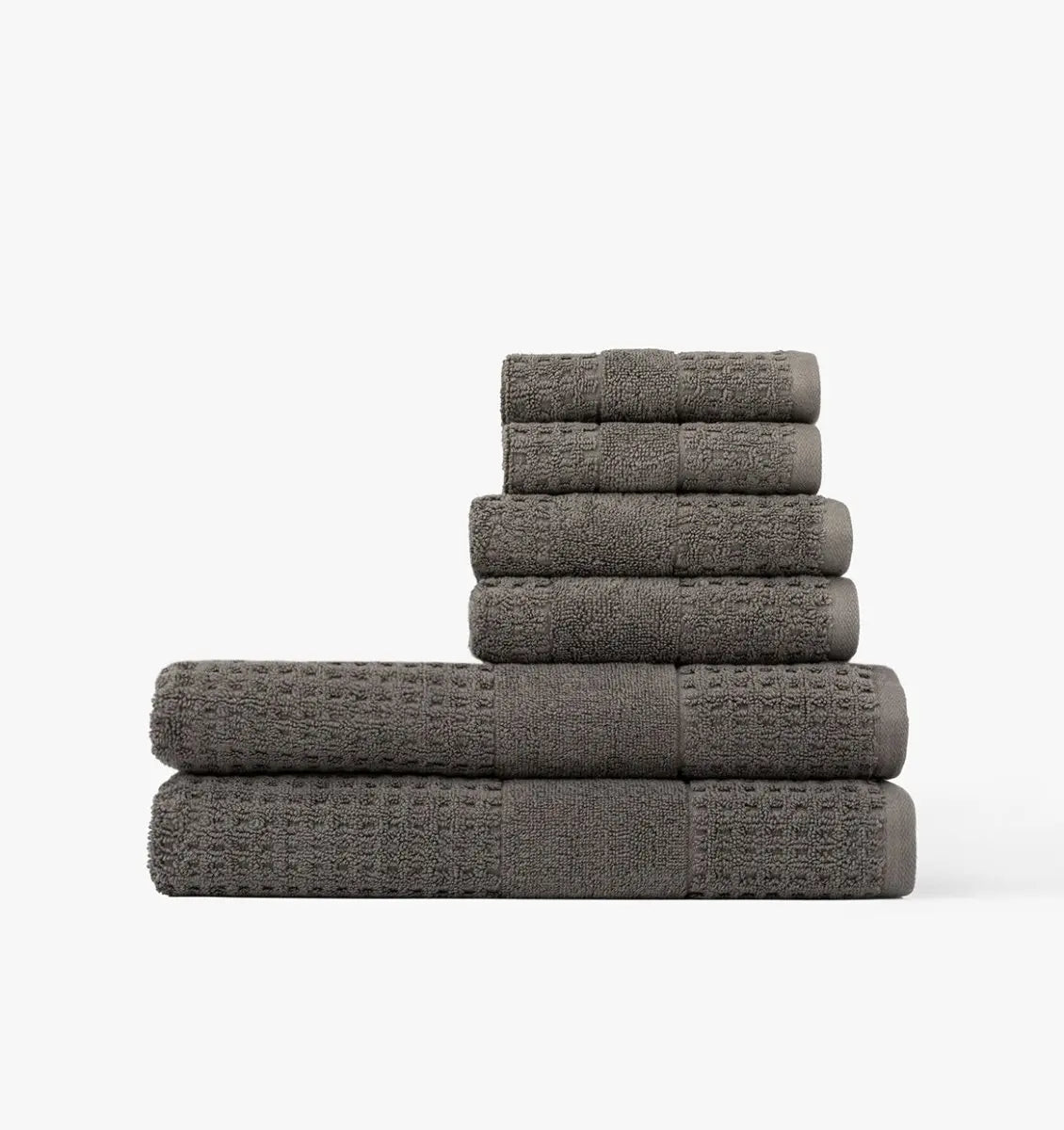 Stack of gray waffle towels on a white background