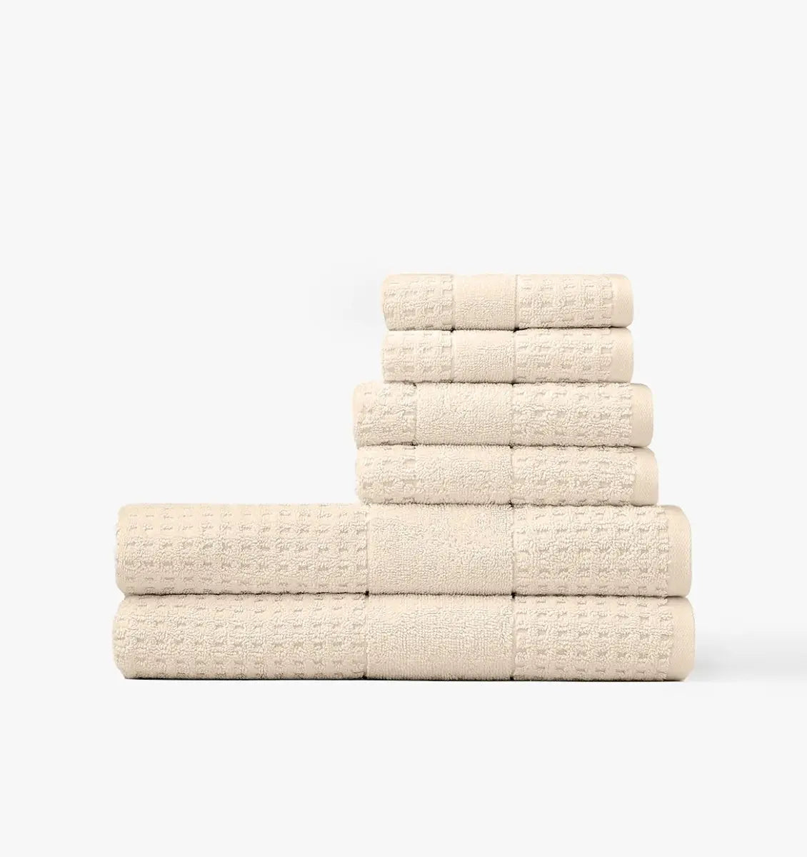 Stack of cream towels on a white background