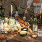 Picnic setting with various Voluspa Candles including French Cade Lavender Classic Candle | Duman Home
