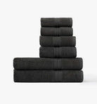Stack of Super plush Towel bundles in dark grey coal color on a white background