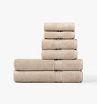 Stack of super plush taupe towels on a white background
