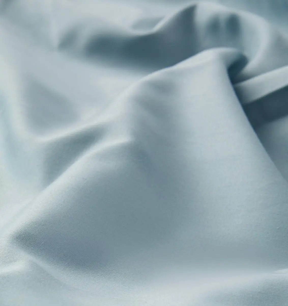 Close-up of textured light blue sheet set fabric