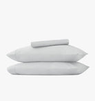 Set of two pillowcases and light gray sheet set on a white background