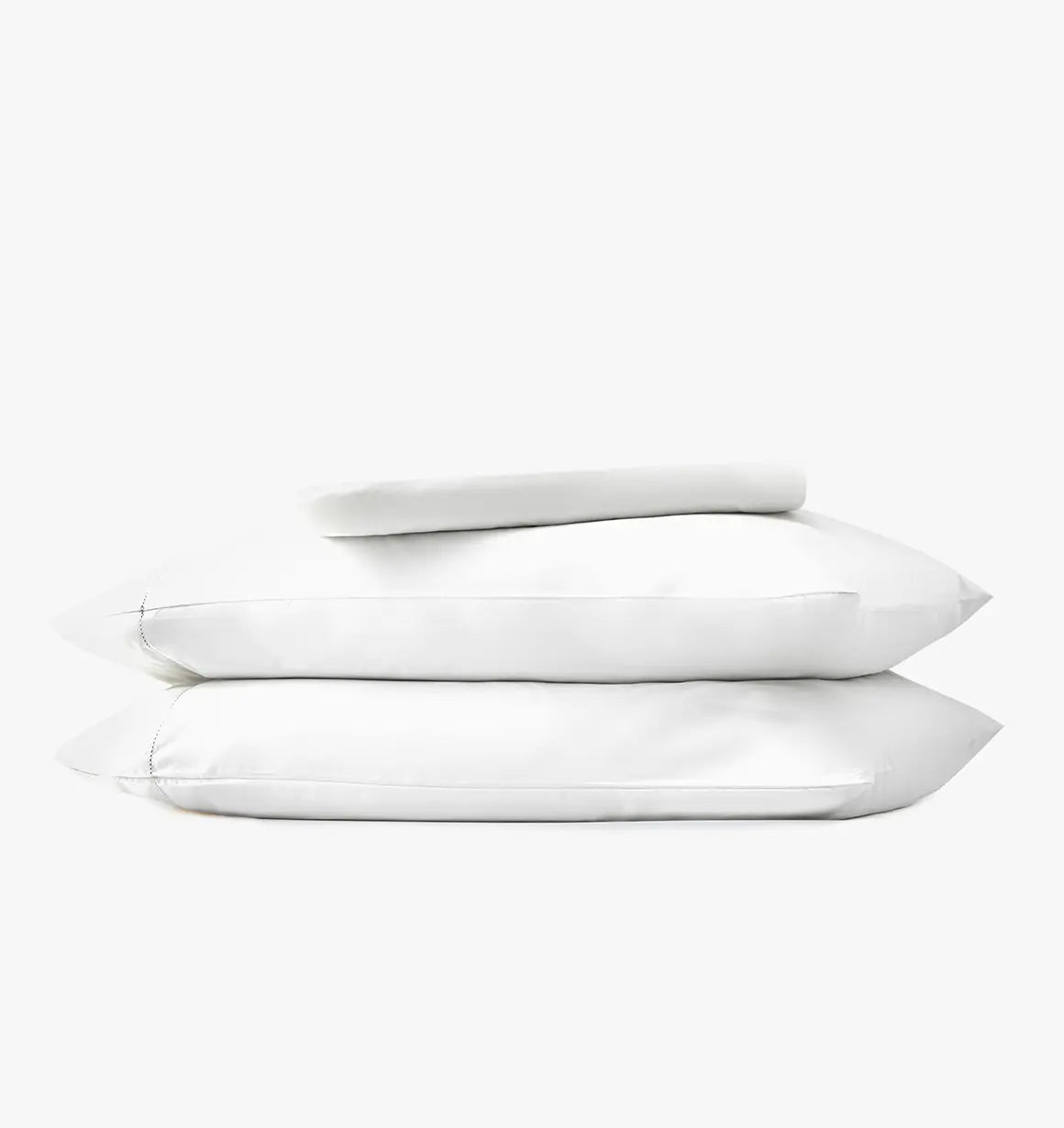 Stack of white pillows and bed sheets on a white background